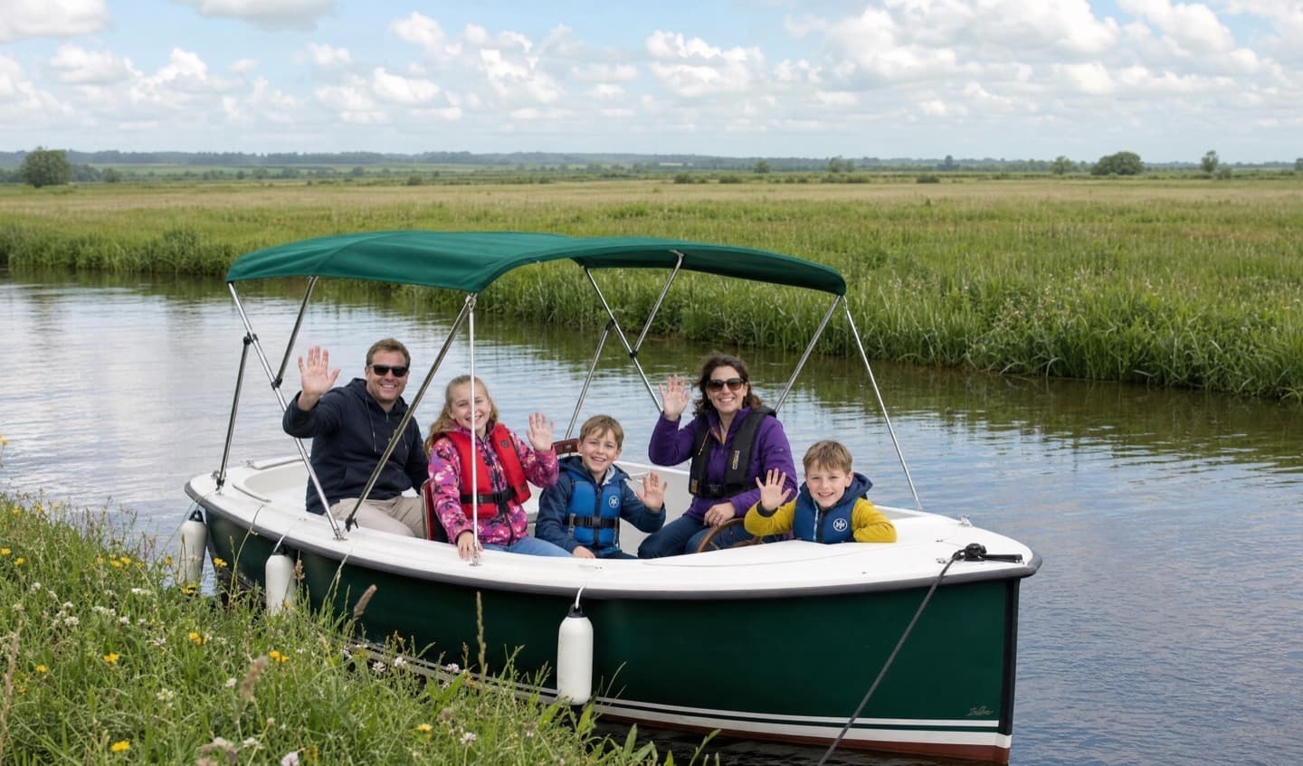 A family of five waving from The Lapwing, drawn up against a grassy bank with the Callows stretching away behind them